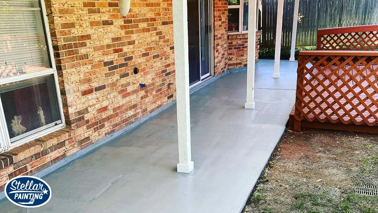 A house with pillar was painted with white paint and brown deck.