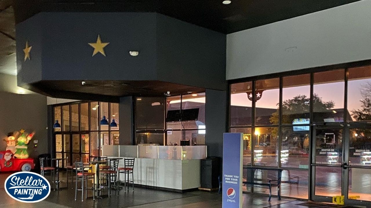 Commercial Painting Alexandra Meadows Fort Worth, TX - Special Services - Stellar Painting This is a commercial interior painting project by Stellar Painting in Alexandra Meadows Fort Worth, TX, showing a freshly painted lobby area with dark accent walls and seating.