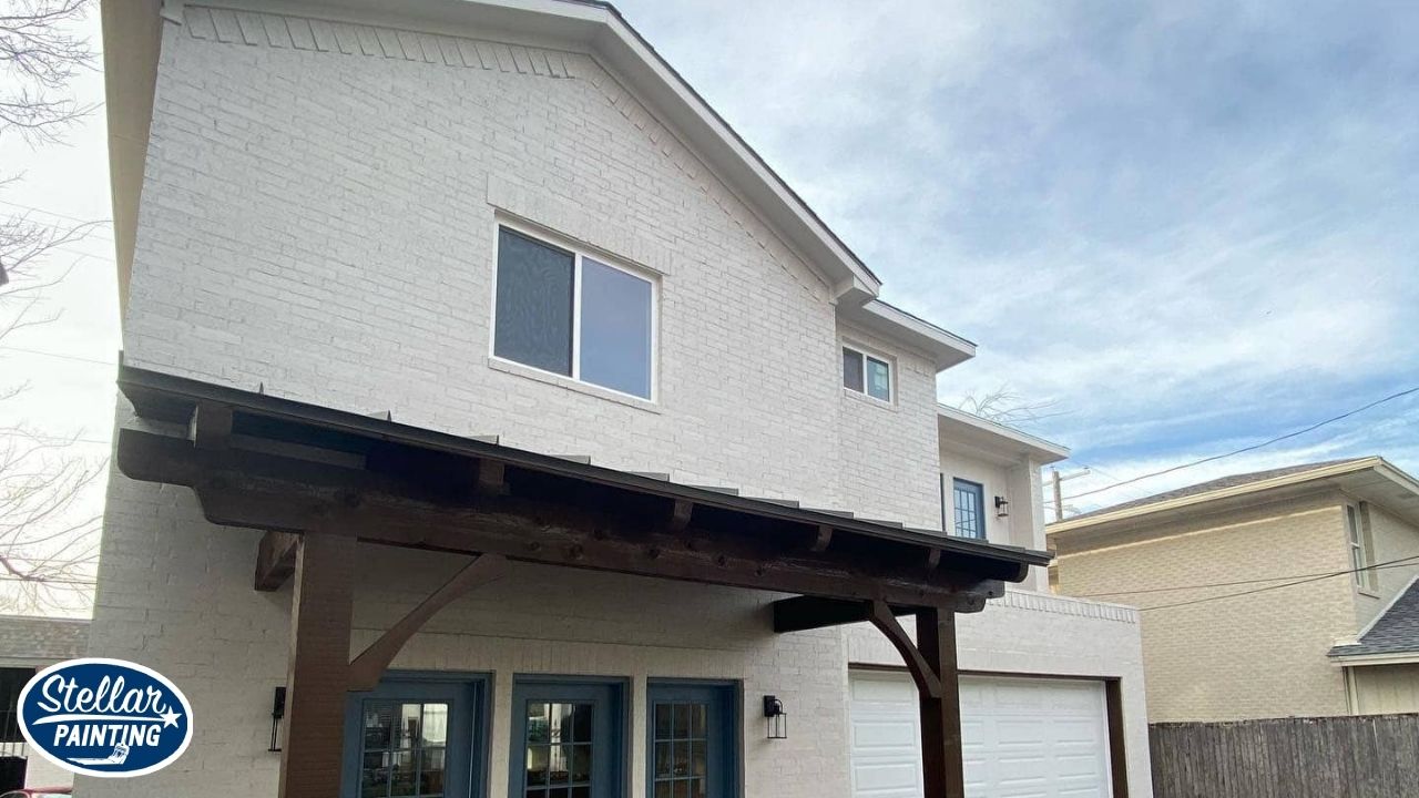 House Painters Alexandra Meadows Fort Worth - Experience & Expertise - Stellar Painting This is an exterior painting project by Stellar Painting in Alexandra Meadows Fort Worth, TX, featuring a two-story white brick home with blue trim and wooden pergola.