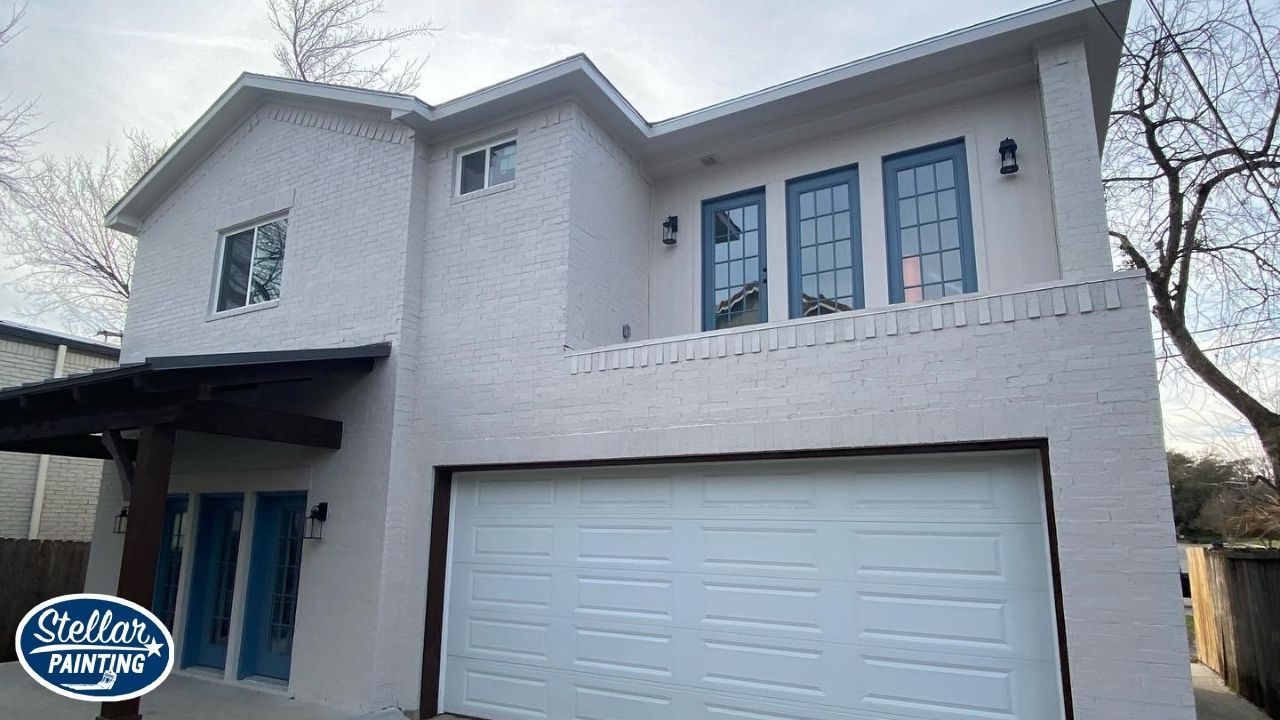 House Painters Alexandra Meadows Fort Worth, TX - Attention to Detail - Stellar Painting This is an exterior painting project by Stellar Painting in Alexandra Meadows Fort Worth, TX, highlighting a freshly painted white brick facade with blue French doors and second-story windows.
