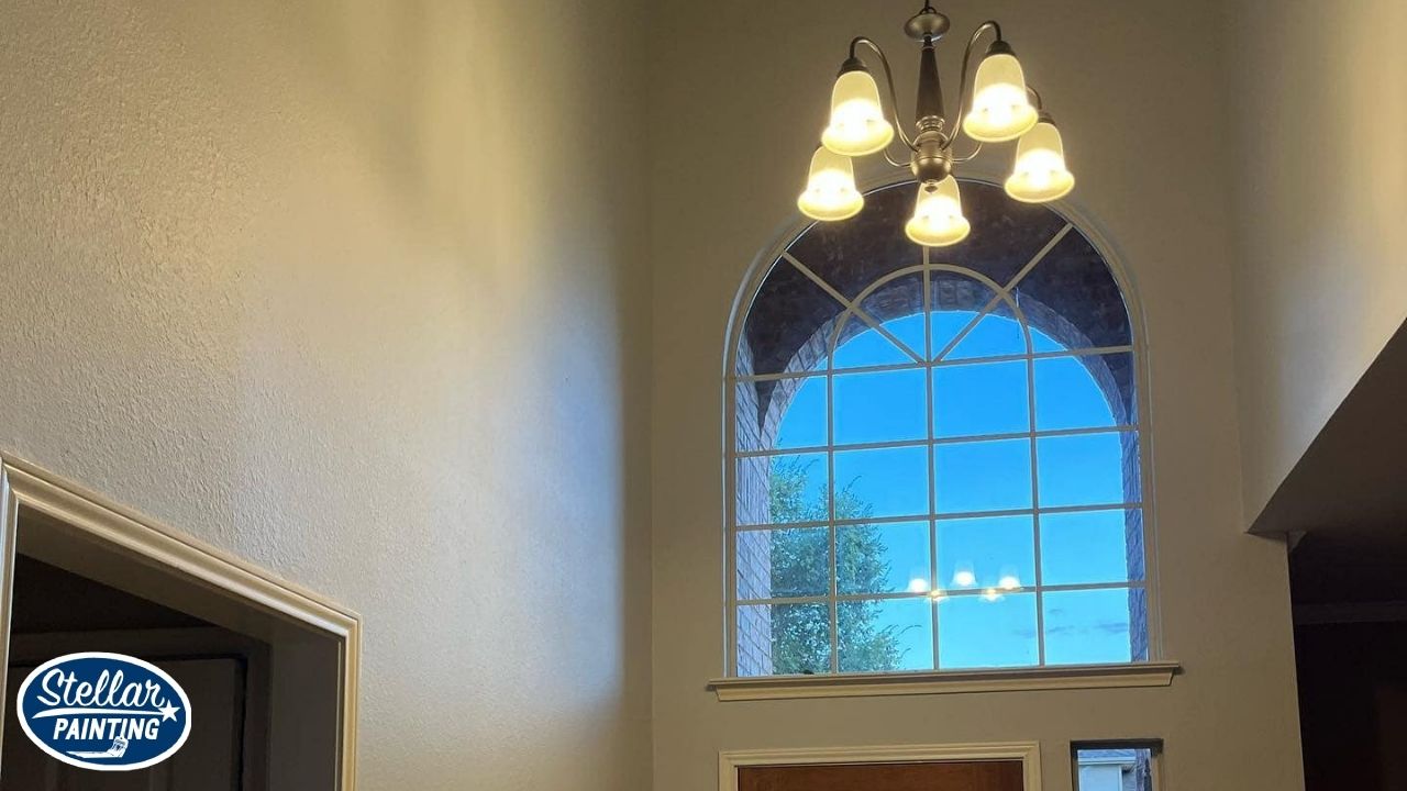 Interior Painting Alexandra Meadows Fort Worth, TX - Room Types - Stellar Painting This is an interior painting project by Stellar Painting in Alexandra Meadows Fort Worth, TX, showing a tall entryway wall with arched window and chandelier.