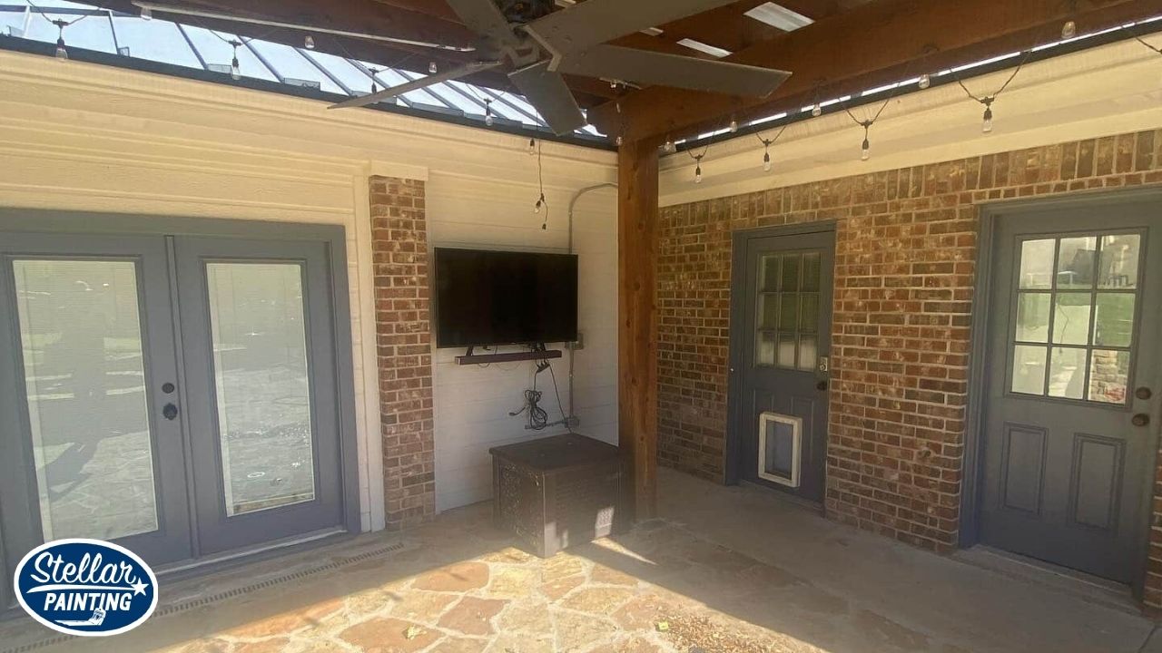 This is a painted outdoor space in Alexandra Meadows Fort Worth, TX, featuring stone flooring and updated door finishes.