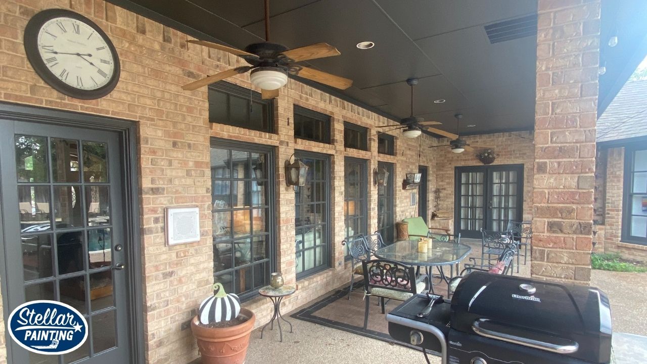 This is an exterior residential painting project in Alexandra Meadows Fort Worth, TX, showing a covered patio with painted doors and ceiling.